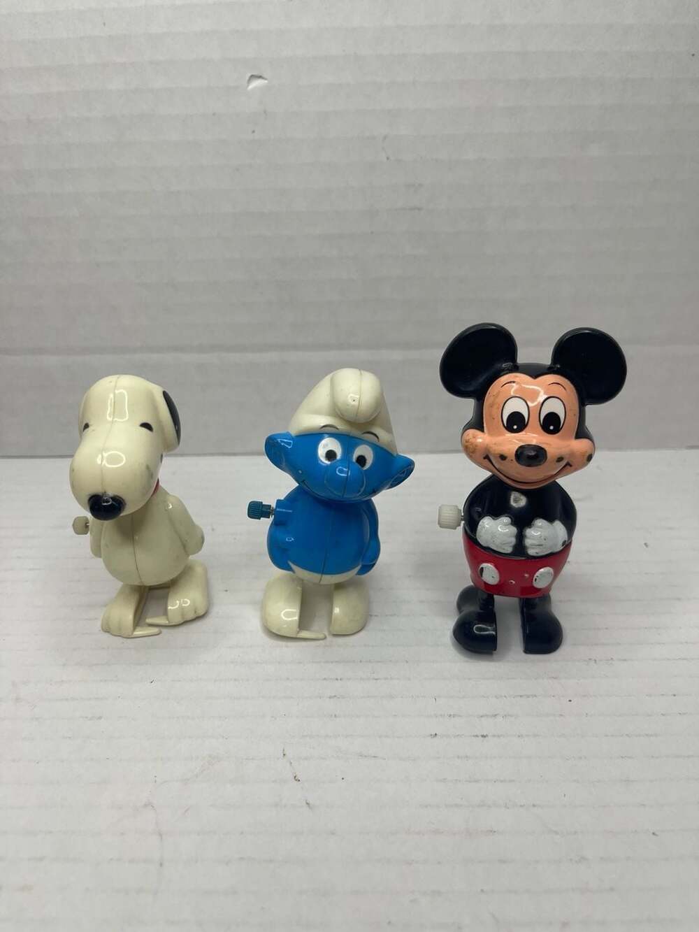 Vintage Wind-Up Toy Lot: Aviva Snoopy, Wallace Berrie Smurf, Tomy Mickey Mouse